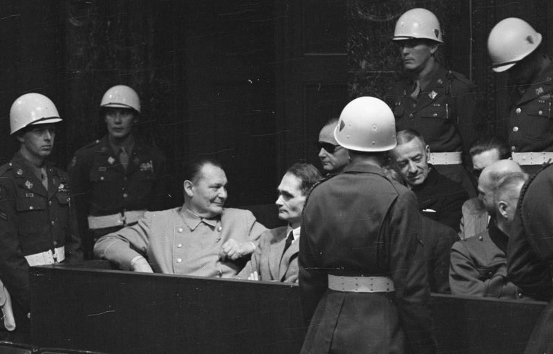 A break in the proceedings: defendants in a relaxed moment. Left to right: Goering, Hess, and, in the back row, Admirals Karl Doenitz (in the shades) and Erich Raeder. 